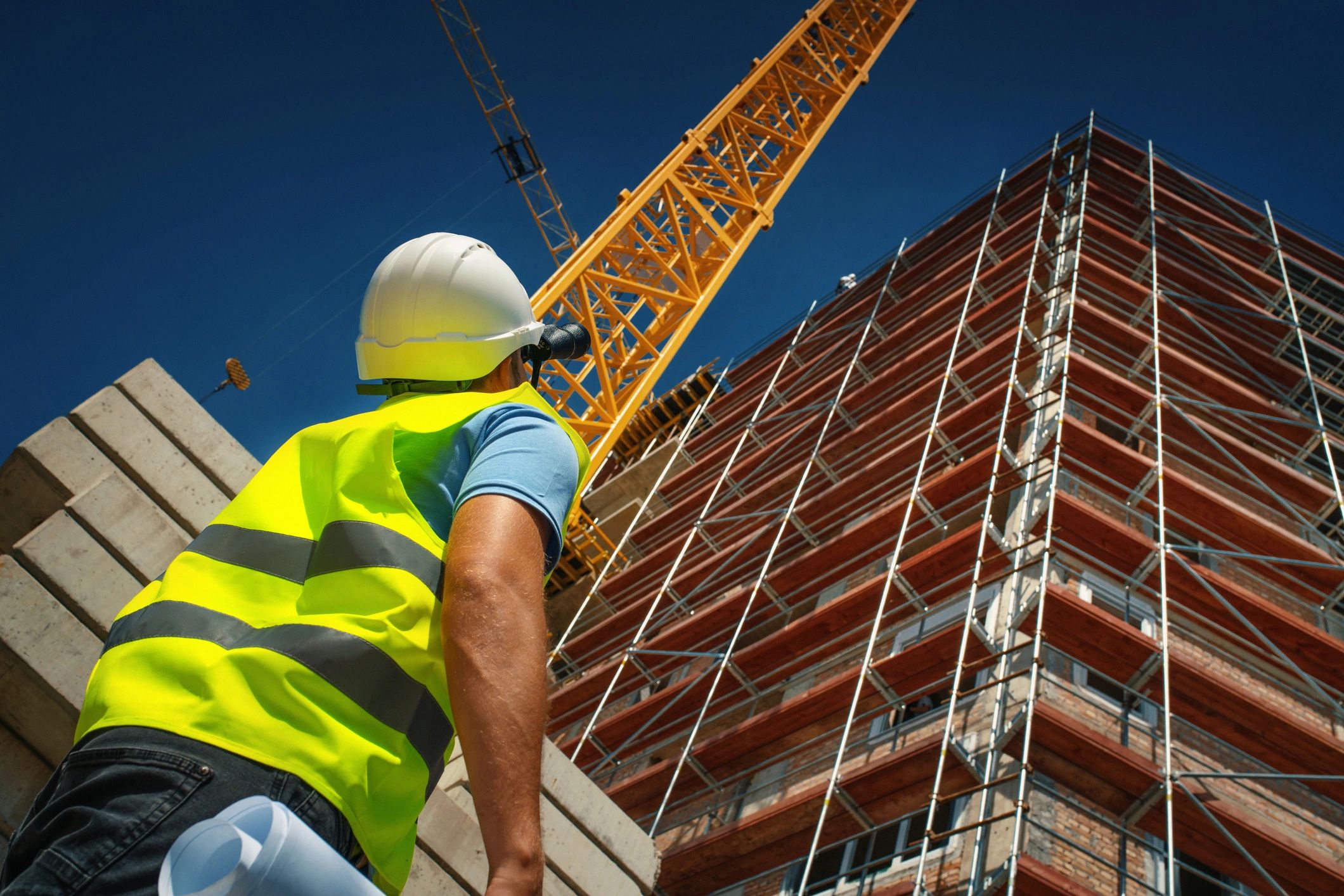 Construction professionals reviewing building plans on-site